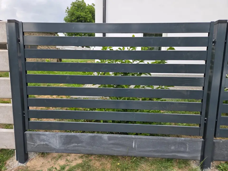 Przęsło ogrodzenia palisadowego w kolorze grafitowym na betonowej podmurówce